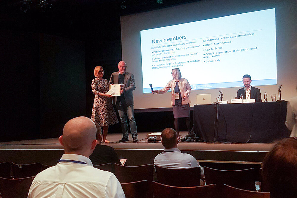 Ms. Elvira Leka, NAHLA Director receiving the Membership Certificate from Mr. Uwe Gartenschlaeger, EAEA President