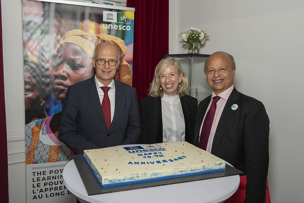 UIL birthday cake and three high representatives of the city of Hamburg and of adult education